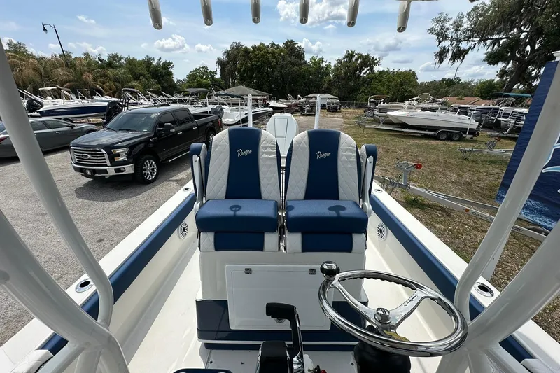 Slide: The Image of 2026 Ranger 2660 Bay boat interior with dual blue seats and steering wheel. - 22