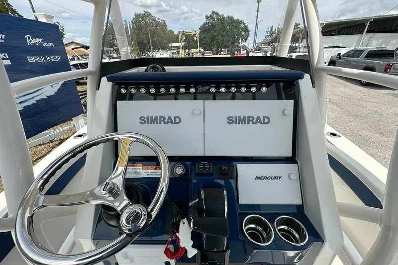 Slide: The Image of Helm of 2026 Ranger 2660 Bay boat with Simrad electronics and Mercury controls. - 24