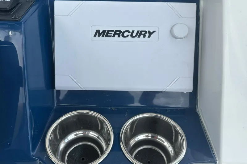 Slide: The Image of Control panel of 2026 Ranger 2660 Bay boat with Mercury branding and dual cup holders. - 28