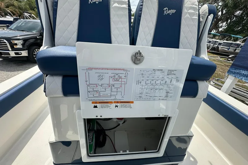 Slide: The Image of 2026 Ranger 2660 Bay boat interior with blue and white seating and control panel. - 30