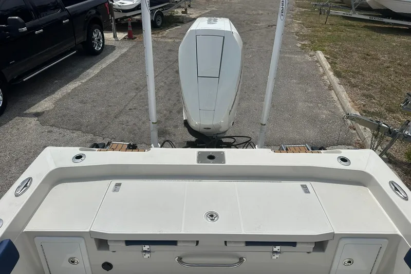 Slide: The Image of 2026 Ranger 2660 Bay boat with outboard motor, parked on a trailer. - 31