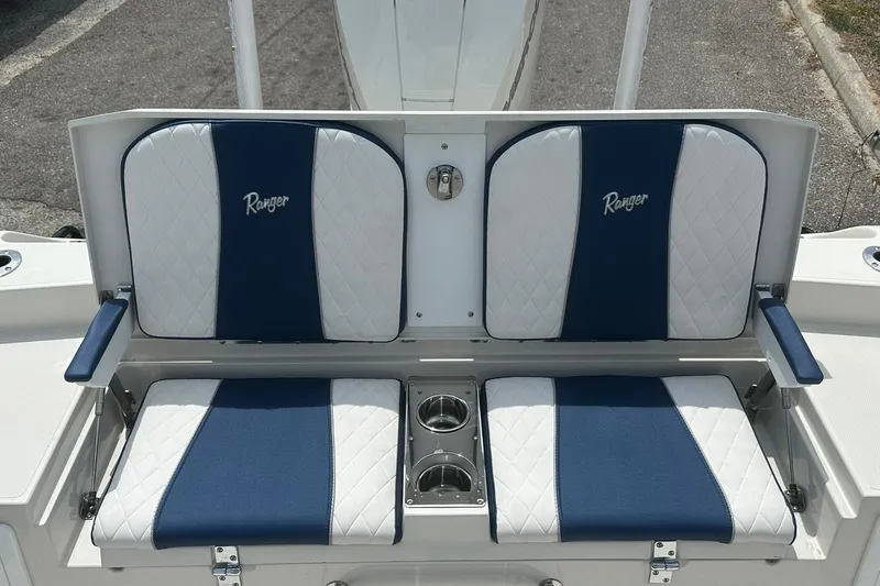Slide: The Image of 2026 Ranger 2660 Bay boat seating with blue and white upholstery and cup holders. - 33