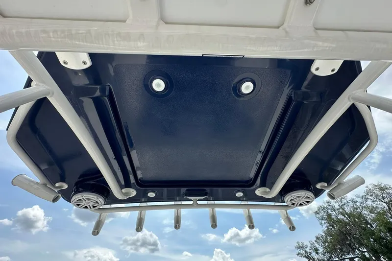 Slide: The Image of Underside view of 2026 Ranger 2660 Bay boat's T-top with speakers and rod holders. - 35