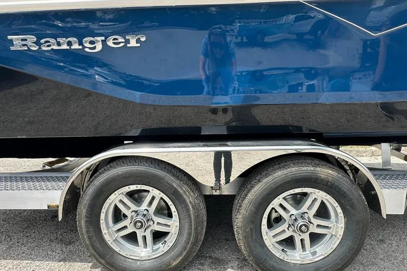 Slide: The Image of 2026 Ranger 2660 Bay boat on trailer, showcasing sleek blue hull and dual wheels. - 44