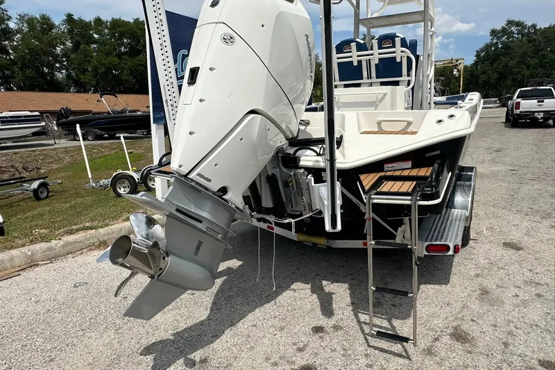 Slide: The Image of 2026 Ranger 2660 Bay boat with powerful outboard motor and trailer, parked outdoors. - 48