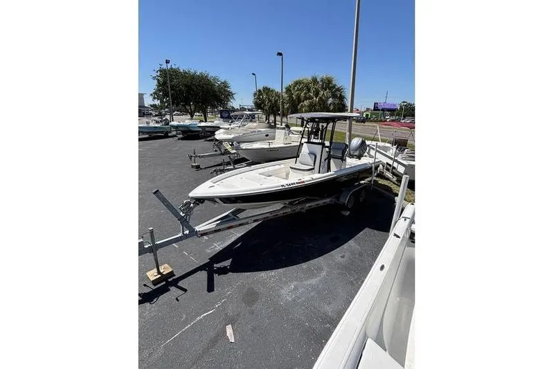 Slide: The Image of 2018 ShearWater 25 LTD boat on trailer in parking lot under clear sky. - 10