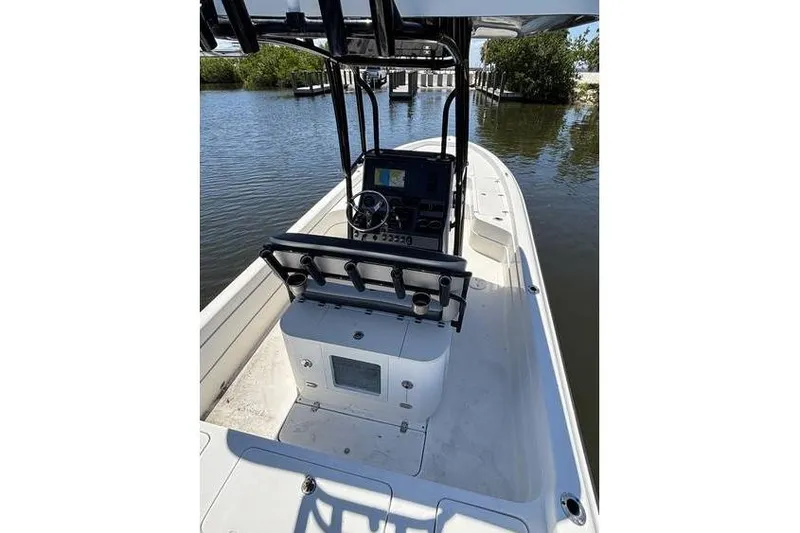 Slide: The Image of 2018 ShearWater 25 LTD boat with console and steering wheel on calm water. - 11