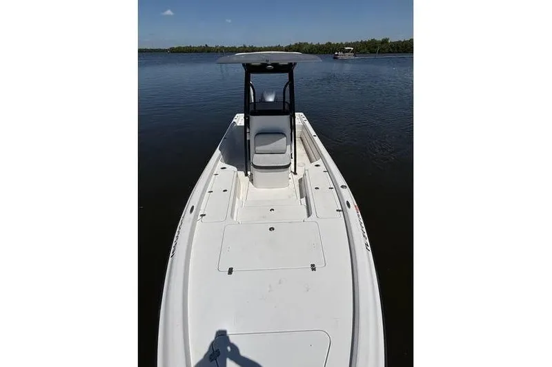 Slide: The Image of 2018 ShearWater 25 LTD boat on calm water, featuring sleek white deck design. - 6