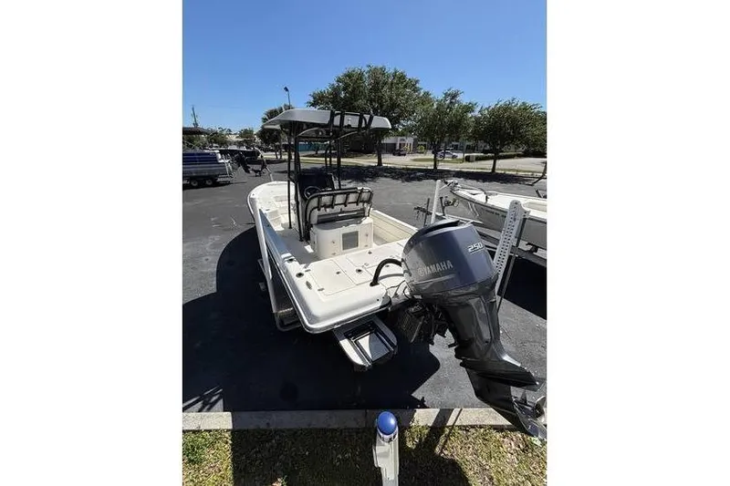 Slide: The Image of 2018 ShearWater 25 LTD boat with Yamaha outboard motor, parked outdoors. - 7