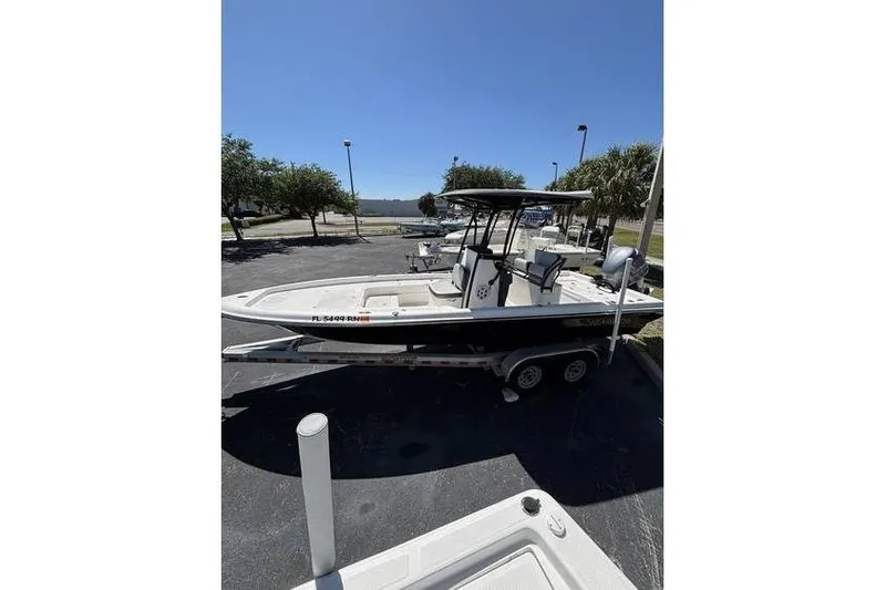 Slide: The Image of 2018 ShearWater 25 LTD boat on trailer in sunny parking lot. - 9