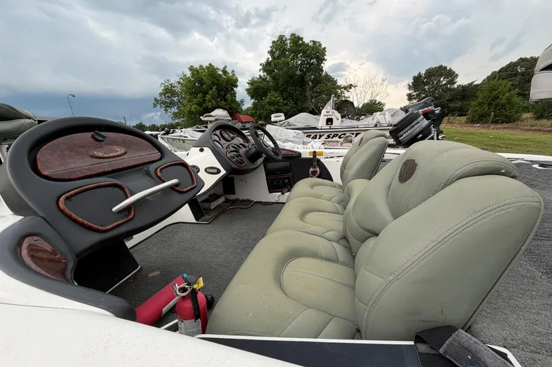 Slide: The Image of 2001 Triton Tr-19 boat interior with steering wheel and cushioned seats. - 3