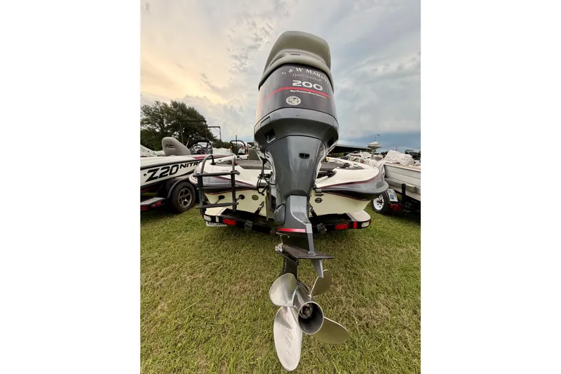 Slide: The Image of 2001 Triton Tr-19 boat with powerful outboard motor on grassy area. - 6