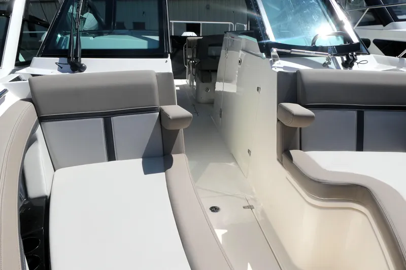 Slide: The Image of 2026 Boston Whaler 330 Vantage boat interior with cushioned seating and sleek design. - 15