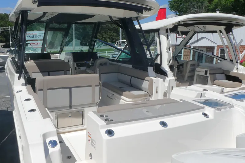 Slide: The Image of 2026 Boston Whaler 330 Vantage boat interior with seating and helm station. - 2