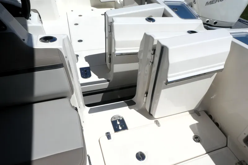 Slide: The Image of 2026 Boston Whaler 330 Vantage boat interior with seating and storage compartments. - 4