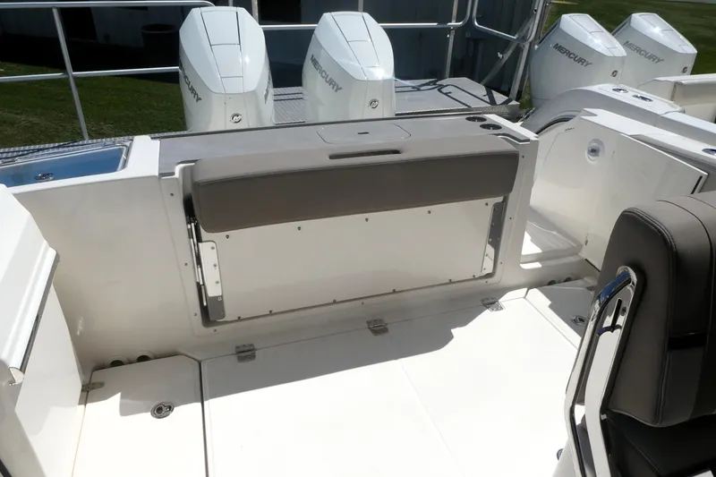 Slide: The Image of 2026 Boston Whaler 330 Vantage boat interior with Mercury engines and seating area. - 5