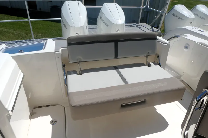 Slide: The Image of 2026 Boston Whaler 330 Vantage boat interior with seating and Mercury engines. - 6