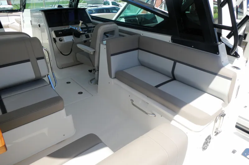 Slide: The Image of Interior of 2026 Boston Whaler 330 Vantage boat, featuring sleek seating and modern controls. - 8