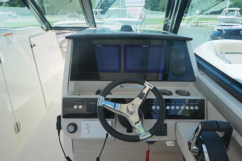 Slide: The Image of 2026 Boston Whaler 330 Vantage helm with modern controls and navigation screens. - 9