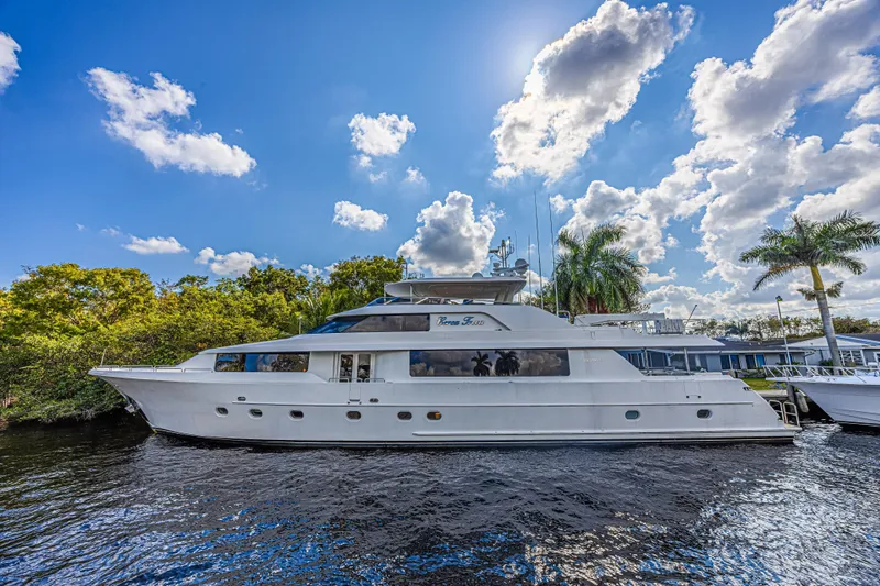 The Image of Luxurious 2011 Westport 112 yacht docked under a vibrant blue sky. - 0