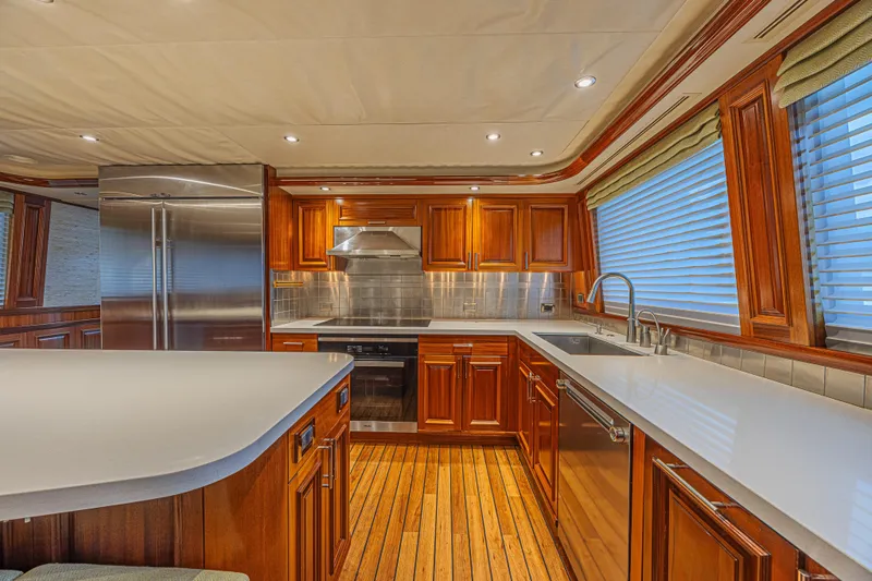 Slide: The Image of Luxurious kitchen interior on 2011 Westport 112 yacht with wood cabinetry and modern appliances. - 25