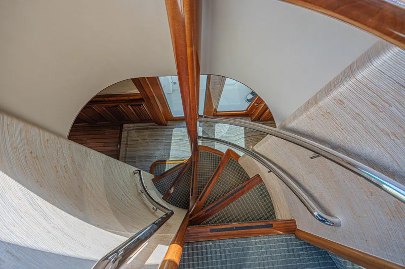 Slide: The Image of Elegant spiral staircase on 2011 Westport 112 yacht, featuring wood and metal accents. - 27