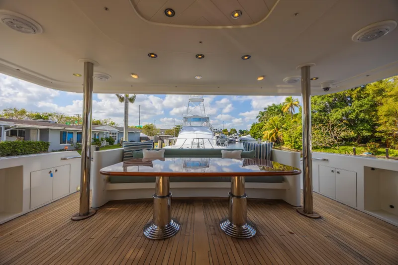 Slide: The Image of Luxurious 2011 Westport 112 yacht deck with elegant seating and polished table. - 3