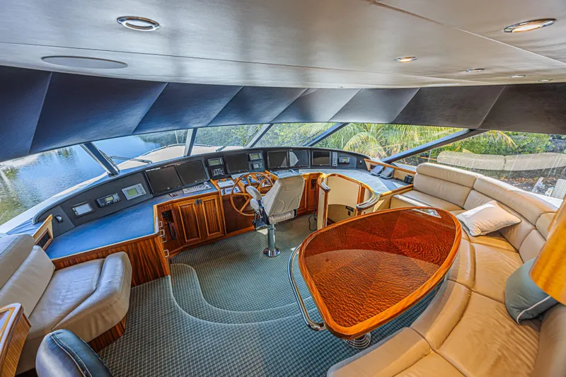Slide: The Image of Luxurious 2011 Westport 112 yacht interior with helm, plush seating, and elegant wood finishes. - 36