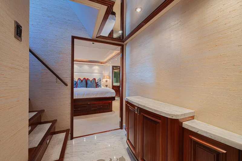 Slide: The Image of Luxurious interior of 2011 Westport 112 yacht featuring elegant bedroom and wooden staircase. - 42
