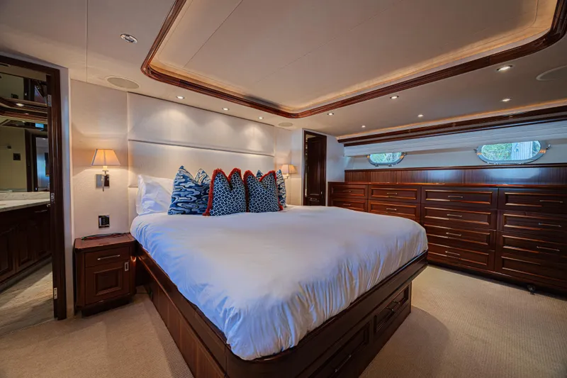 Slide: The Image of Luxurious bedroom interior on a 2011 Westport 112 yacht, featuring elegant wood finishes. - 45