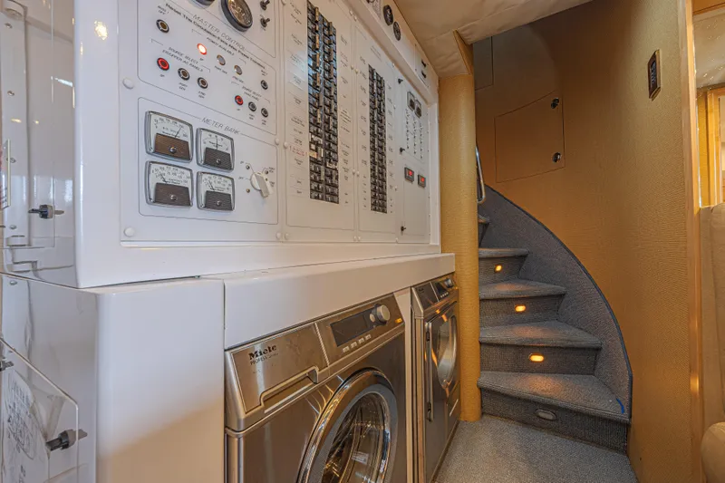 Slide: The Image of Laundry area and control panel on 2011 Westport 112 yacht with spiral staircase. - 62