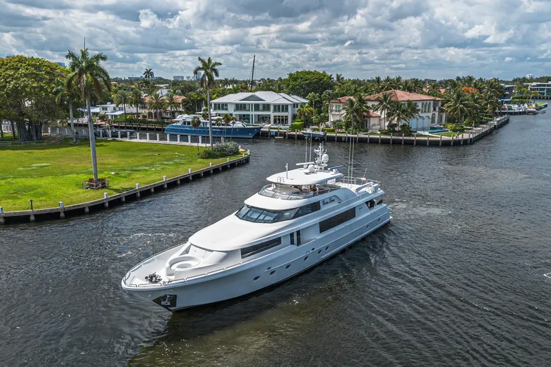 Slide: The Image of Luxurious 2011 Westport 112 yacht cruising near waterfront homes under cloudy skies. - 69