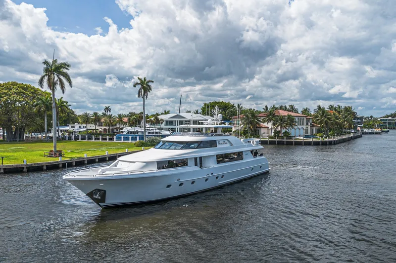 Slide: The Image of Luxurious 2011 Westport 112 yacht cruising near waterfront homes under cloudy skies. - 70