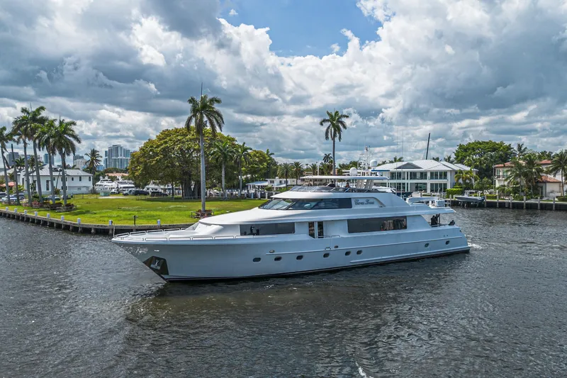 Slide: The Image of Luxurious 2011 Westport 112 yacht cruising near palm-lined waterfront homes. - 71