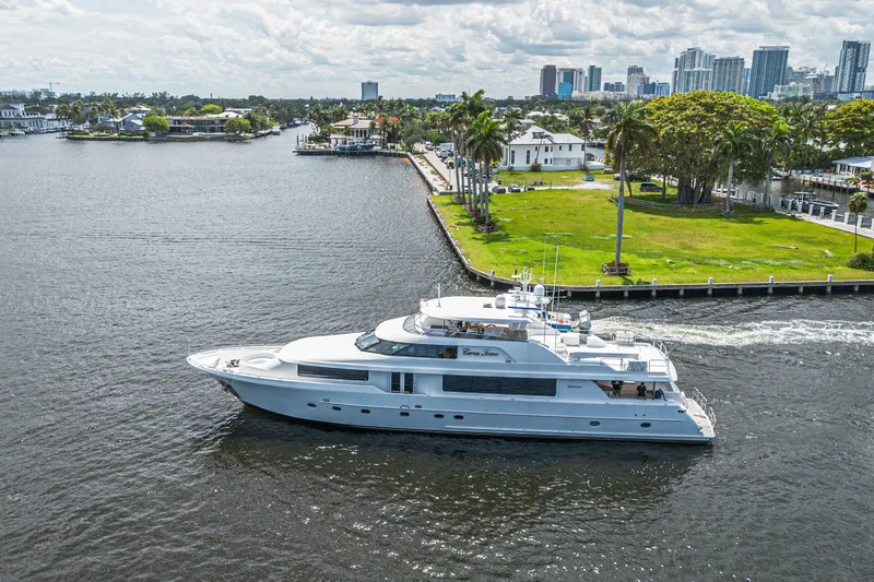 Slide: The Image of Luxurious 2011 Westport 112 yacht cruising near a scenic waterfront cityscape. - 73