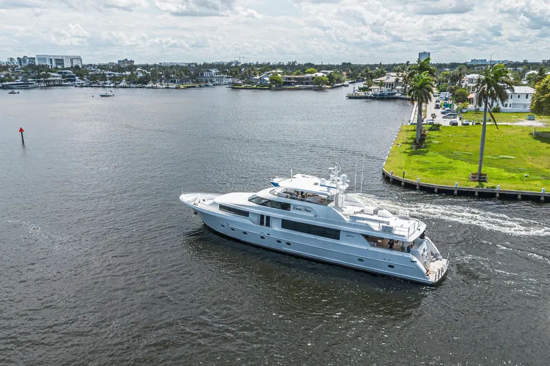 Slide: The Image of Luxurious 2011 Westport 112 yacht cruising near a scenic waterfront area. - 74
