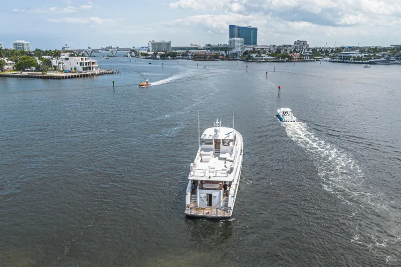 Slide: The Image of Luxurious 2011 Westport 112 yacht cruising in a scenic harbor setting. - 76