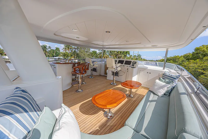 Slide: The Image of Luxurious 2011 Westport 112 yacht deck with seating, bar, and helm station. - 8