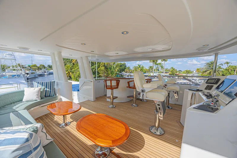 Slide: The Image of Luxurious 2011 Westport 112 yacht deck with seating, helm, and tropical views. - 9
