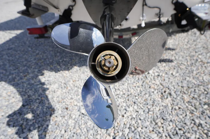 Slide: The Image of Close-up of a 2024 Carolina Skiff 182 boat propeller on gravel surface. - 12