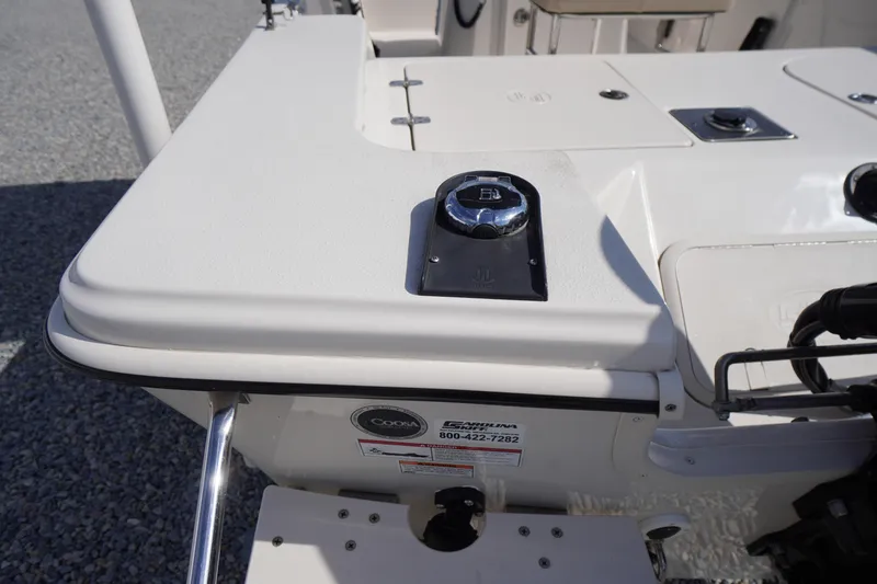 Slide: The Image of 2024 Carolina Skiff 182 boat deck with control panel and storage compartments. - 14