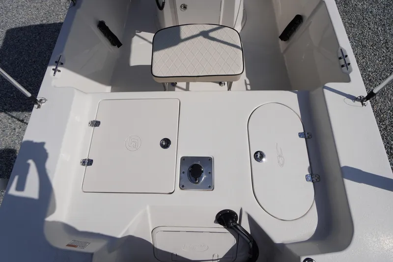 Slide: The Image of 2024 Carolina Skiff 182 boat interior with seating and storage compartments. - 16