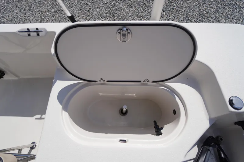 Slide: The Image of 2024 Carolina Skiff 182 boat livewell with open lid, showcasing interior features. - 18