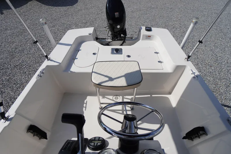 Slide: The Image of 2024 Carolina Skiff 182 boat interior with steering wheel and seating. - 19