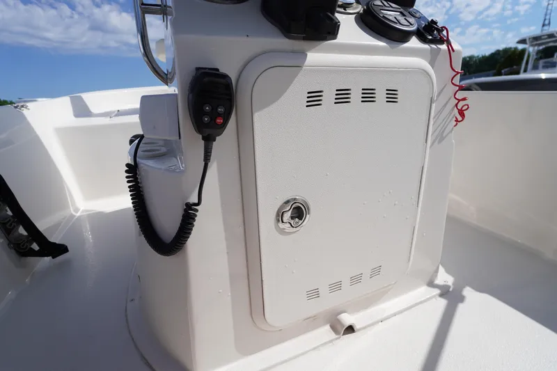 Slide: The Image of 2024 Carolina Skiff 182 boat console with radio and storage compartment. - 27