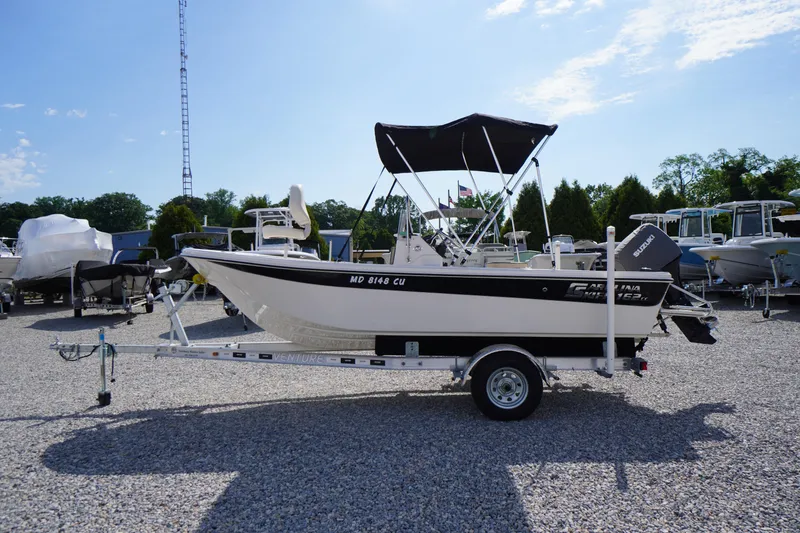 Slide: The Image of 2024 Carolina Skiff 182 boat on trailer, outdoor display, sunny day. - 5