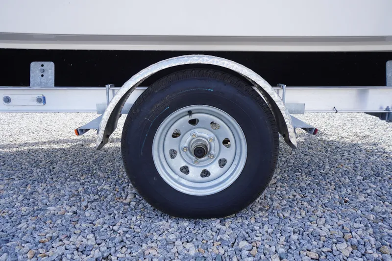 Slide: The Image of Trailer wheel of 2024 Carolina Skiff 182 on gravel surface. - 8