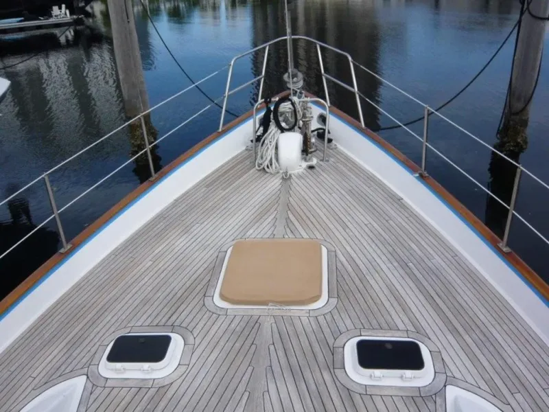 Slide: The Image of Deck of 1990 Cheoy Lee Sloop with wooden finish and hatches, docked at marina. - 12