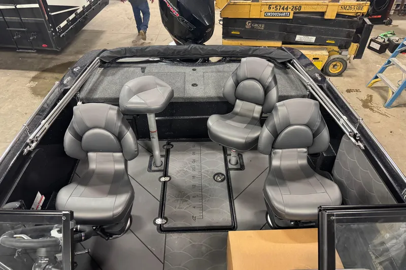 Slide: The Image of 2026 Nitro ZV19 Sport Pro boat interior with four gray seats in a workshop setting. - 10