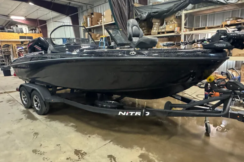 Slide: The Image of 2026 Nitro ZV19 Sport Pro boat in a garage, on a trailer, with visible equipment. - 13